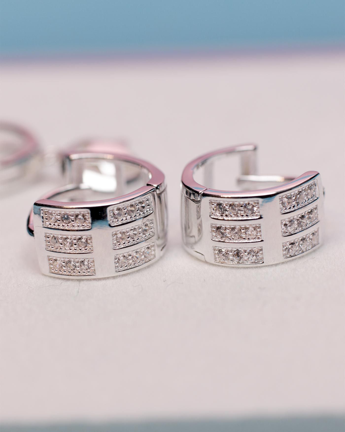 elegant hoop earrings 925 sterling silver blue background