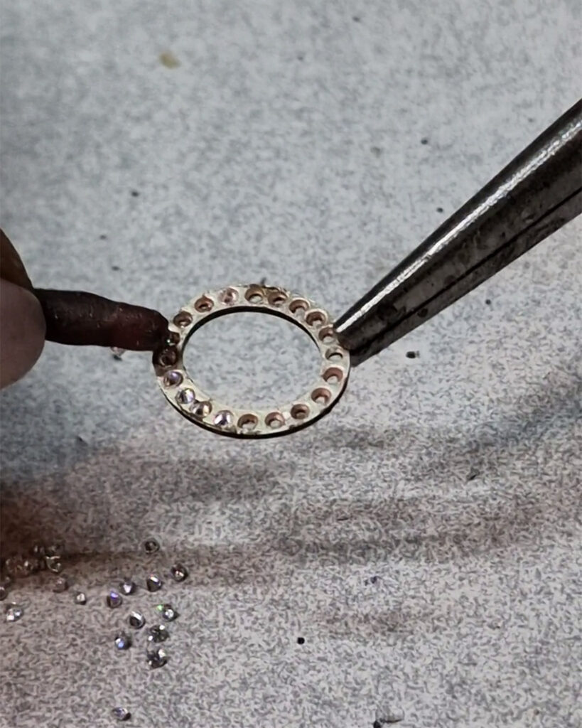 placing zirconias by hand on silver jewelry manufacturing process